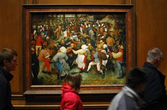 Visitors walk past Breughel's 'Wedding Dance' in the Detroit Intitute of Art