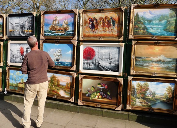 The art market at entry level, paintings for sale on the railings in Green Park, London.