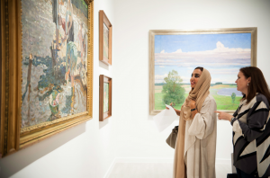 A lady considers the Tkachev brothers 1956 painting 'Laundresses' at an exhibition in Abu Dhabi.